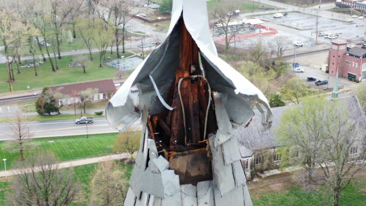 A close up shot of the tallest finial shows damages left behind by the 2023 lightning strike at MacKay Hall, including metal, wood and roofing tiles that were destroyed and burned. 